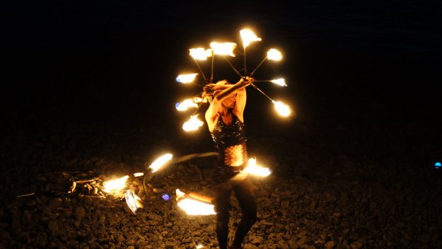 Fire dancing girl on a Canary Island beach